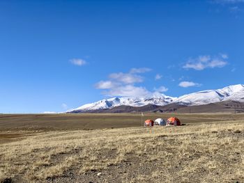 People on snowcapped mountain against sky