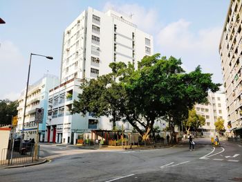 View of city street and buildings against sky