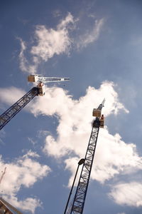 Low angle view of crane against sky