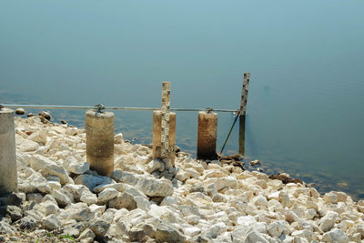 Depth marker on rocks at lakeshore