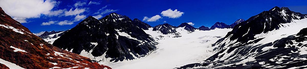 Panoramic view of snowcapped mountains against sky during winter
