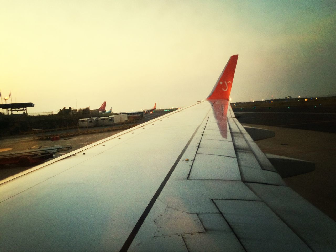 transportation, sky, the way forward, clear sky, road marking, diminishing perspective, vanishing point, cropped, mode of transport, travel, part of, sunlight, outdoors, road, copy space, aircraft wing, no people, long, flying, day