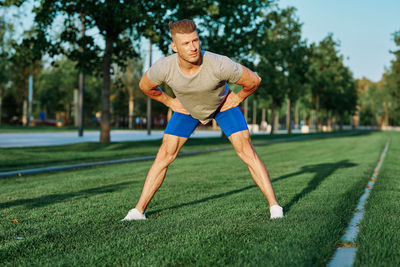 Young man exercising on field