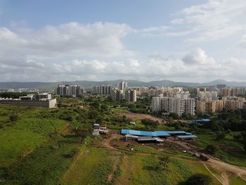 High angle view of city against cloudy sky