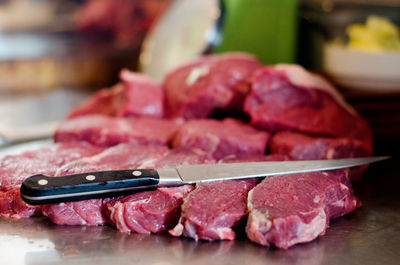 Close-up of meat and knife on table