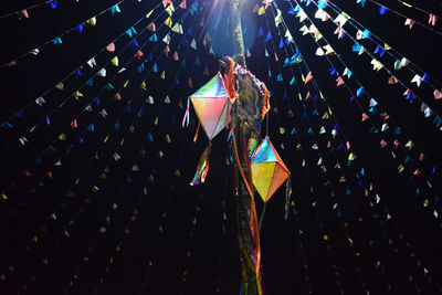 Low angle view of multi colored decoration against sky at night