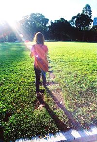 Full length of woman standing on grassy field