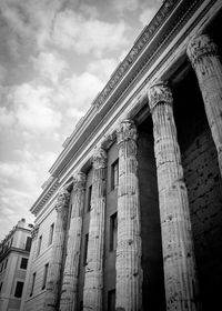 Low angle view of historic building against cloudy sky