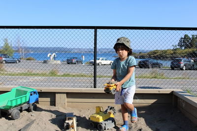 Portrait of boy playing with toy car