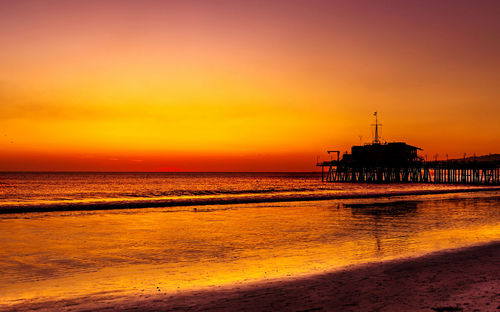 Scenic view of sea against orange sky