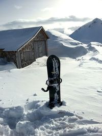 Snowboard sticking out from snow