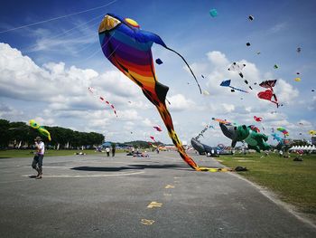 People flying against sky