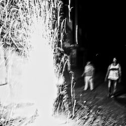 Blurred motion of people standing by grass