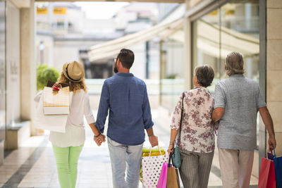 Rear view of people walking outdoors