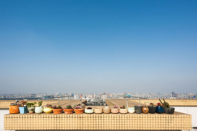 Buildings in city against clear blue sky