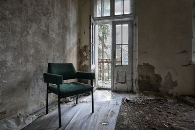 Empty chair in abandoned building