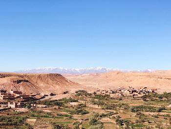 Scenic view of desert against clear blue sky