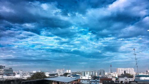 Buildings in city against blue sky