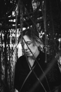 Portrait of young man against trees