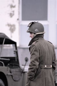 Side view portrait of man standing by car