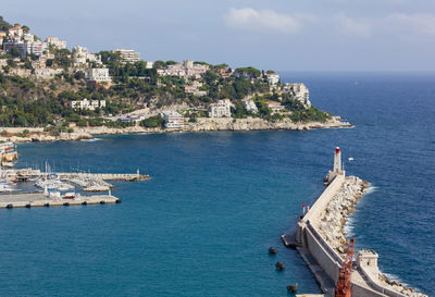 High angle view of sea by buildings against sky