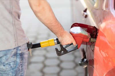 Midsection of man repairing car