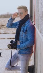 Full length of young man photographing with camera