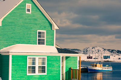 House by building against sky