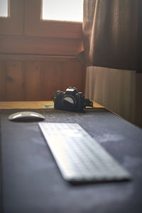 Close-up of camera on table at home