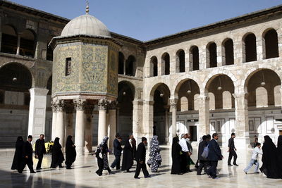 People walking at umayyad mosque during sunny day