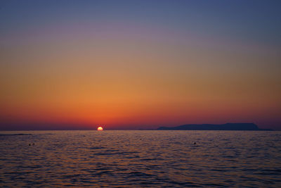 Scenic view of sea against orange sky