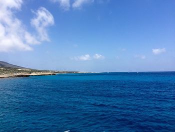 Scenic view of sea against cloudy sky