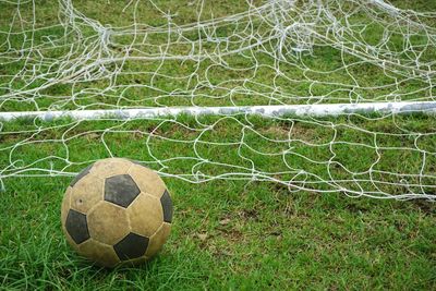 Close-up of soccer ball on grassy field