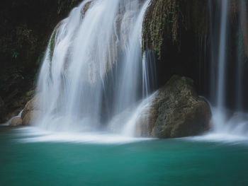 Scenic waterfall smooth stream, turquoise pond in rainforest. erawan falls, kanchanaburi, thailand.