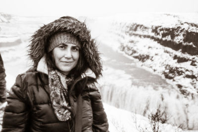 Portrait of smiling woman standing outdoors during winter