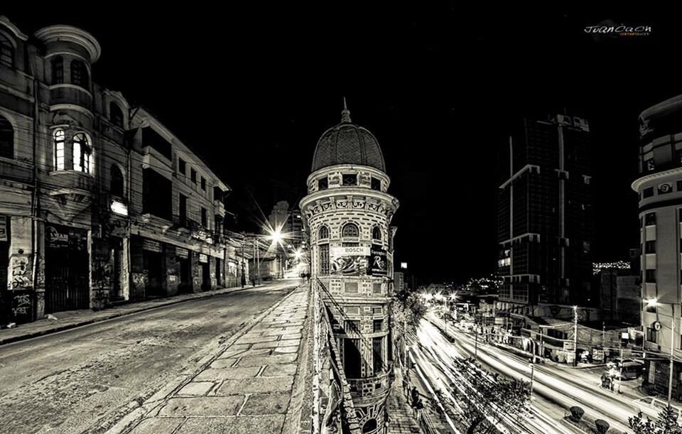 architecture, night, building exterior, built structure, illuminated, transportation, road, city, street, the way forward, light trail, communications tower, travel destinations, city street, sky, city life, outdoors, high street, diminishing perspective, residential district, curve