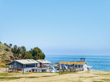 House at beach against clear sky