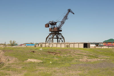 Traditional windmill on field against clear sky