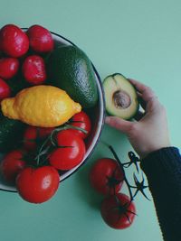 High angle view of hand holding strawberries