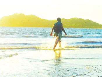 Rear view of people on beach