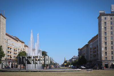 Panoramic shot of buildings against clear blue sky