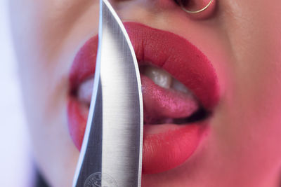 Close-up of woman using mobile knife