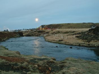 Scenic view of land and sea against sky