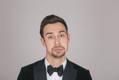 Portrait of young man against white background