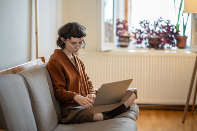 Businesswoman using laptop at home