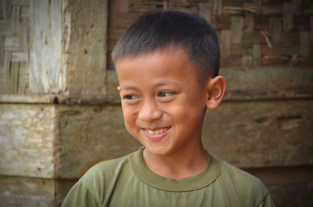 smiling, portrait, looking at camera, happiness, headshot, cheerful, close-up, real people, childhood, one person, people, outdoors, gap toothed, day, adult, human body part, adults only, formal portrait