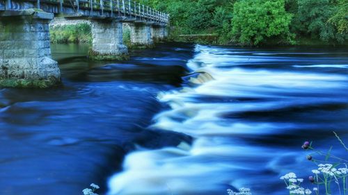 Scenic view of river flowing through rocks