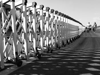 Rear view of people walking on footpath