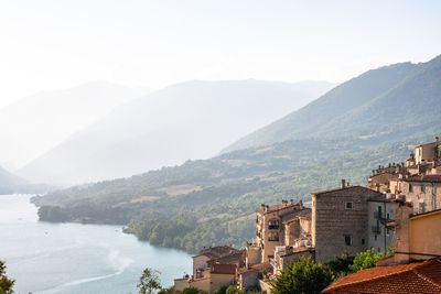 High angle view of lake and buildings against sky