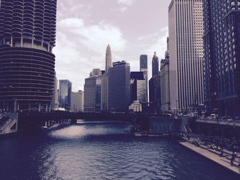 River amidst buildings against sky in city